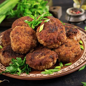 Juicy delicious meat cutlets on a dark table. Russian cuisine.